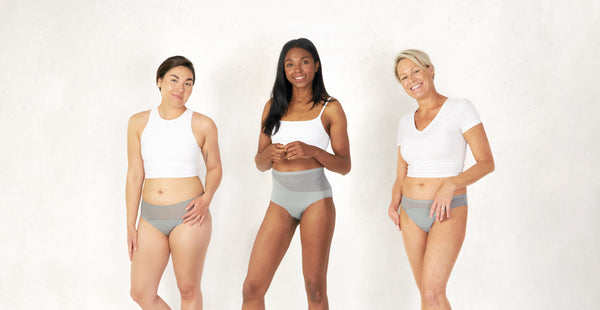 Three models wearing Saalt period underwear in Pebble Grey color.