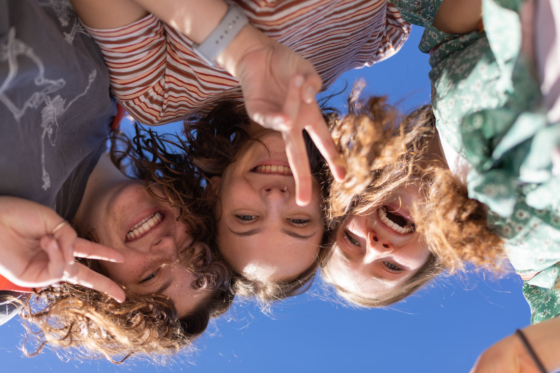 3 girls smiling at a camera 