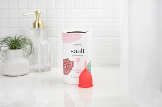 Saalt menstrual cup on bath shelf