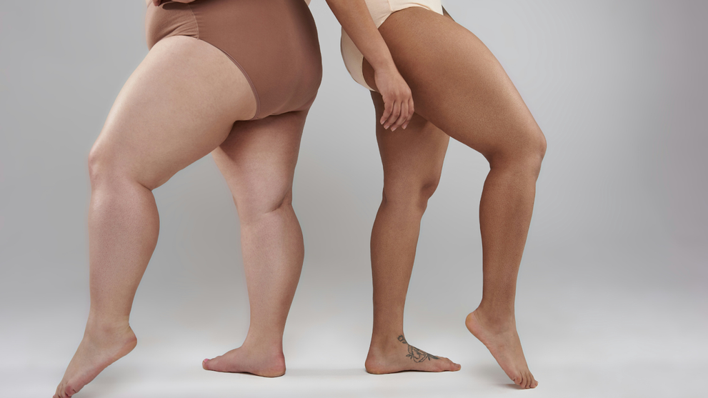 Two Women Standing Back to Back, Posing in Period Underwear