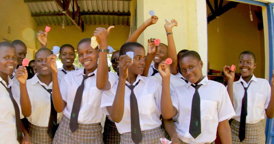 Group of girls holding menstrual cups.