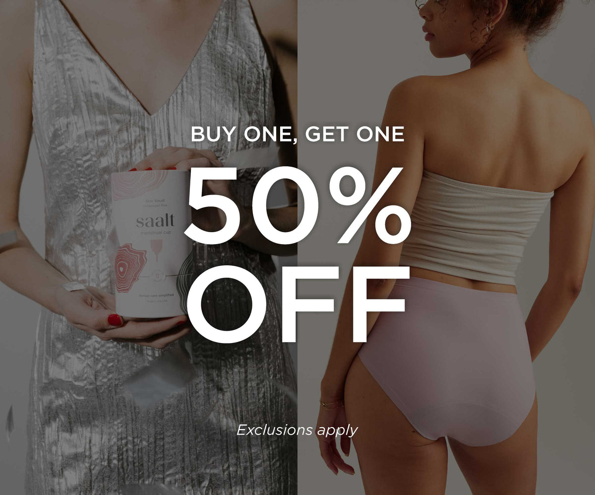 Buy one, get one 50% off. Exclusions apply. Background image shows a split image: on the left, a person in a silver party dress holding a Saalt Cup, while silver confetti flies in the air. On the right, a model is wearing Saalt seamless high waist in the new sunset mauve color.