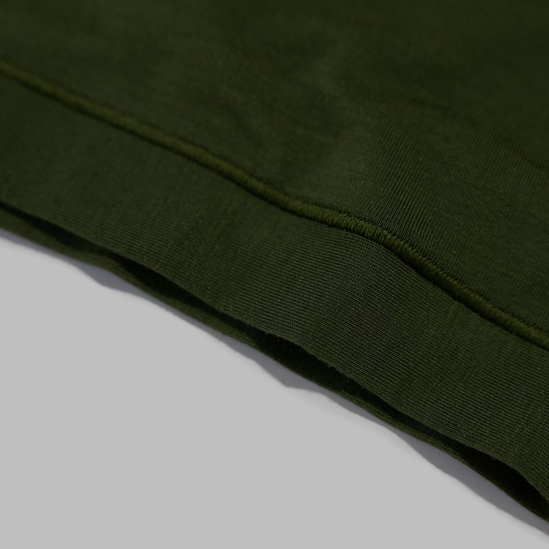 Closeup showing Saalt's Comfort fabric in color Olive Grove.