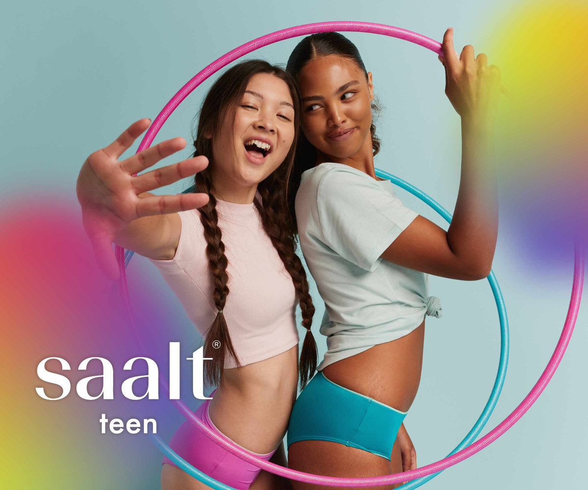 Two models wearing Saalt Teen period underwear, with Saalt teen logo.